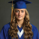 Emilyn Nestibo in a graduation gown and 2024 graduation cap.