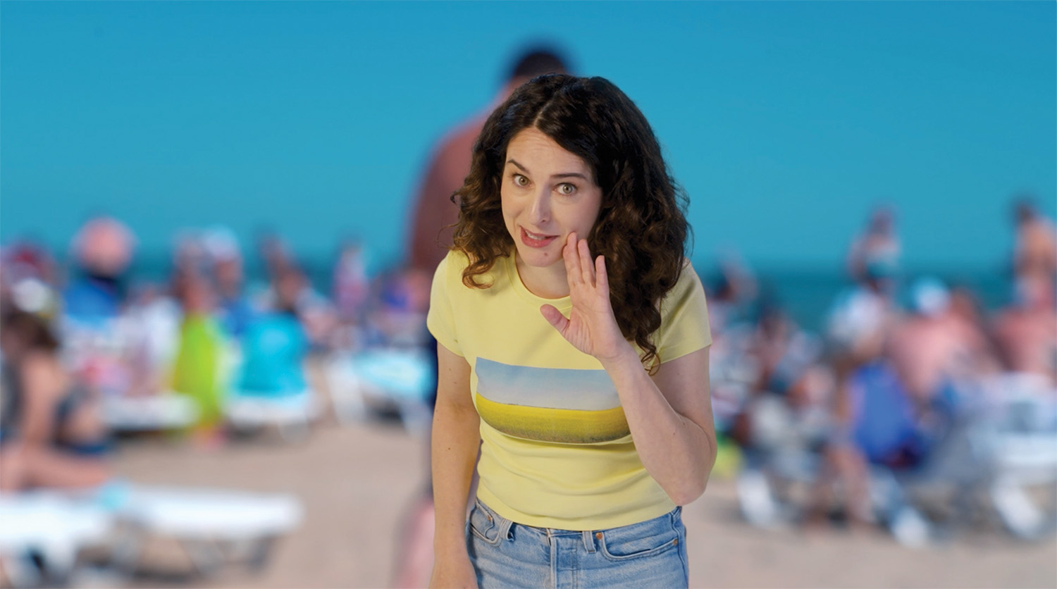 Hello Canadian Canola girl lets the viewer in on a secret, with her hand up to her mouth with a beach in the background