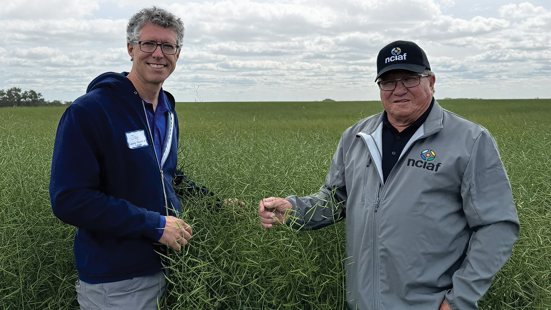 Terry Lerat And Jay Whetter in a canola field together