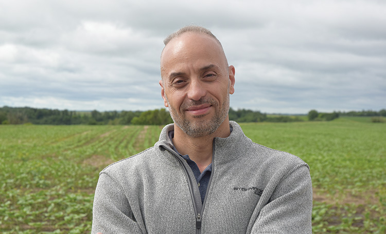 Ahmed Abdelmagid outdoors in a field.