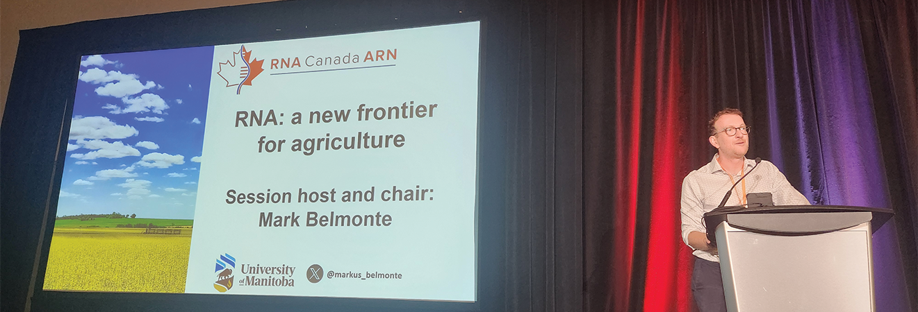 Mark Belmonte gives a speech at a podium, the presentation is titled RNA: a new frontier for agriculture